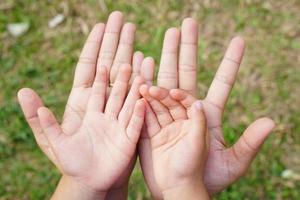 Mother and Child is holding hands to receive something photo