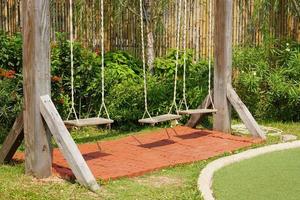 Wooden swings in the playground photo