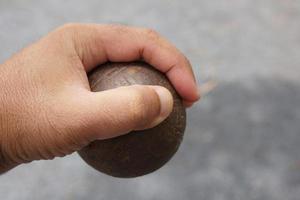 boule in the hand of an athlete photo