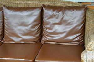 brown pillow is placed on the sofa in a coffee shop. photo