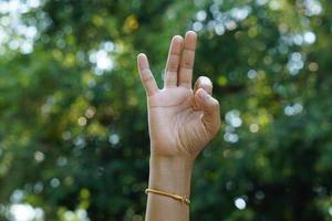 three finger human hand green bokeh background photo