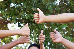 college students working as a team stacking hands concept photo