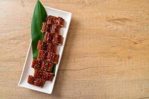 sliced grilled eel or grilled unagi with sauce photo