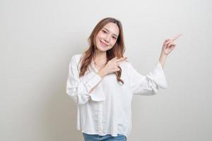 portrait beautiful woman with hand presenting or pointing photo