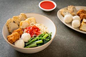 egg noodles with fish balls and shrimp balls in pink sauce, Yen Ta Four or Yen Ta Fo photo