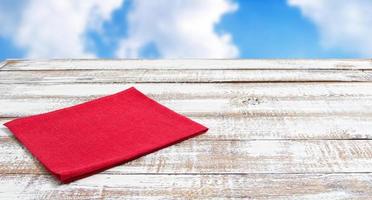coloured napkins on empty wooden table - top view, copy space photo