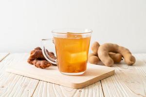 Delicious sweet drink tamarind juice and ice cube photo