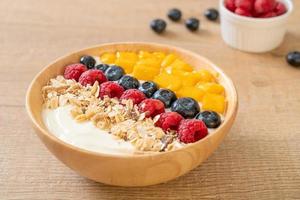 homemade yogurt bowl with raspberry, blueberry, mango and granola photo