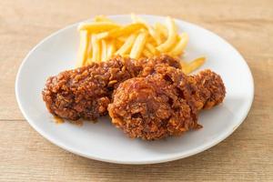 spicy Korean fried chicken with fries photo