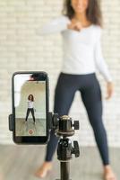 Latin woman created her dancing video by smartphone camera. To share video to social media application. photo