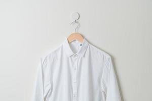 hanging shirt with wood hanger on wall photo