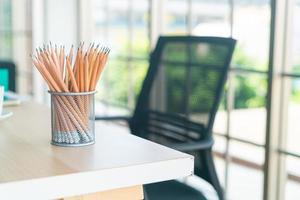 pencil in pencil holder on working table photo