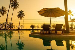 umbrella with bed pool around swimming pool with ocean sea background photo