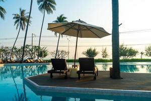 umbrella with bed pool around swimming pool with ocean sea background photo