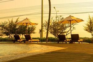 umbrella with bed pool around swimming pool with ocean sea background photo