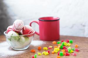 Multicolored cookies in the form of Nuts with filled cream, candied fruit and strainer and cup of coffee on light back photo