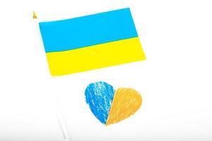 Flag of Ukraine on a white background and paper heart, painted in the color of the flag of Ukraine. The symbol of state photo