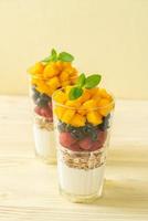 homemade mango, raspberry and blueberry with yogurt and granola photo