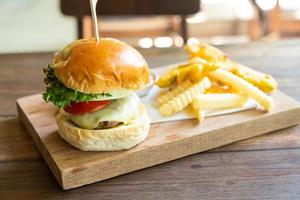 beef burger with cheese and potato chips photo