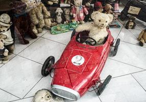 Vienna, Austria, 2014. Teddy bear driving a racing car in a shop window photo