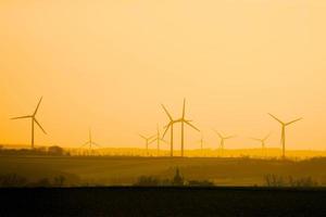Wind turbines skyline, orange sunset photo
