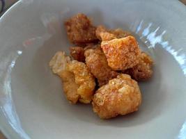 Pork skin fried on a white plate photo