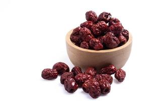 Dried Chinese jujube in a cup on white background. Isolated image. photo