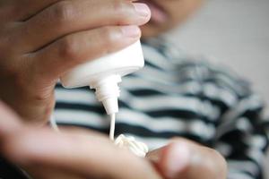 men apply sunscreen cream on hand photo