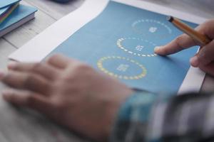 man hand with pen analyzing bar chart on paper photo