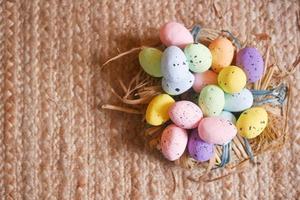 easter concept with multi color egg on pink background. photo