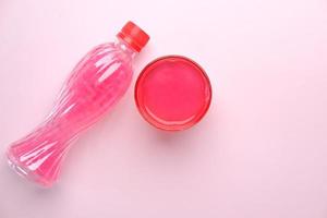 pink color soft drink bottle on table photo