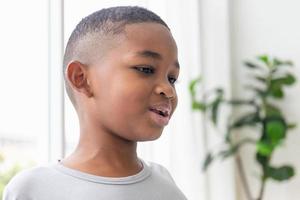 Smiling happy kid boy posing in living room photo