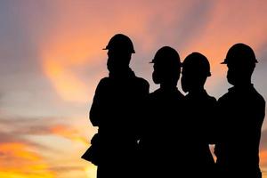 Silhouettes of engineer and workers team with clipping path meeting holding hands together in line, Success Connection and Teamwork Concepts photo