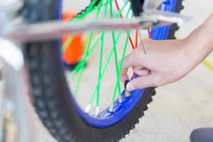 Selective focus of Boy hand fixing bicycle, Mechanical hobby and repair concepts photo