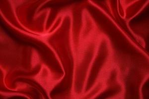 Red cloth waves background texture. photo