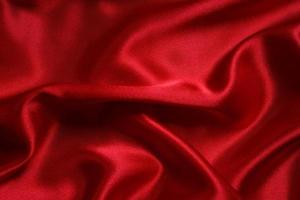 Red cloth waves background texture. photo