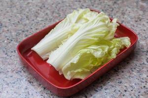 Fresh Chinese Cabbage put on a red plate which was served in Shabu or Sukiyaki restaurant. photo