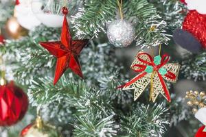 Fir tree or green branch decorated with red, golden and silver colors things as a Christmas or New year background.