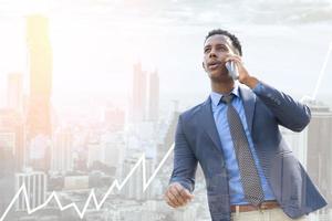 Business people using smartphone in city. Portrait of an handsome businessman. Modern businessman. Confident young man standing outdoors with cityscape in the background photo