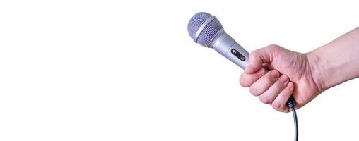 Female hand with microphone, on white background. photo