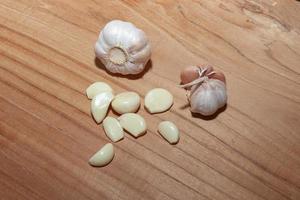 white garlic on wooden floor for cooking photo