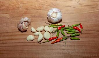 white garlic and Chili on wooden floor for cooking photo