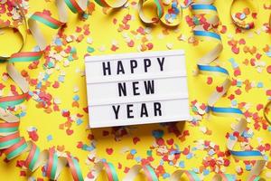happy new year party celebration flat lay with confetti and streamers photo