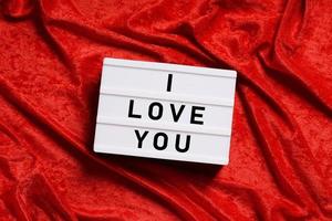 I love you lightbox on red velvet background photo