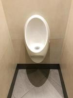 urinal at gentlemen's toilet or men's restroom photo