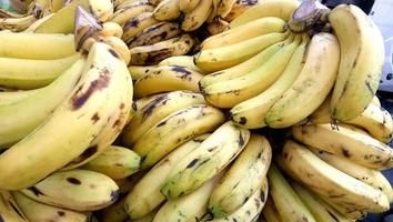 Bunch Of Fresh Bananas At A Street Market In India.These bananas are mature and ready to be eaten. Banana is a food rich of energy. photo