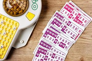 Electronic bingo game with cards and chips to play. Horizontal image viewed from above. photo