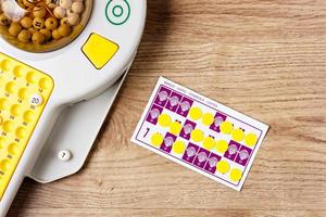 Electronic bingo game with cards and chips to play. Horizontal image viewed from above. photo