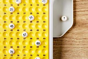 Electronic bingo balls on yellow board. Horizontal image viewed from above. photo