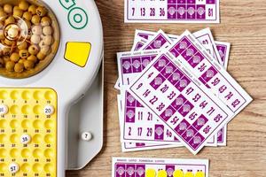 Electronic bingo game with cards and chips to play. Horizontal image viewed from above. photo
